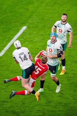 220225 - Wales v Ireland - Guinness Six Nations - Mack Hansen of Ireland and Blair Murray of Wales compete for the ball