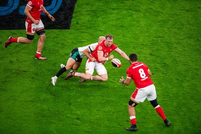 220225 - Wales v Ireland - Guinness Six Nations - Tommy Reffell of Wales passes to Taulupe Faletau of Wales under pressure from Jamison Gibson-Park of Ireland