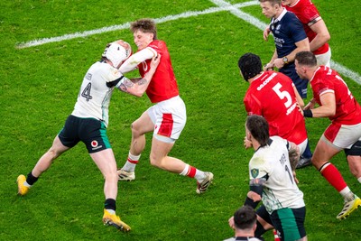 220225 - Wales v Ireland - Guinness Six Nations - Ellis Mee of Wales hands off Mack Hansen of Ireland