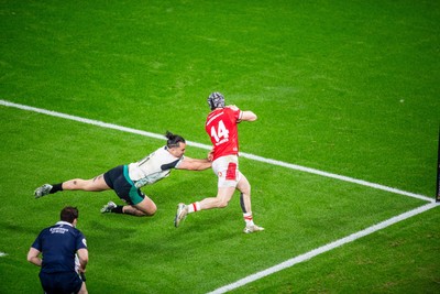 220225 - Wales v Ireland - Guinness Six Nations -  Tom Rogers of Wales beats James Lowe of Ireland to score a try 