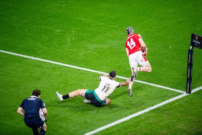 220225 - Wales v Ireland - Guinness Six Nations -  Tom Rogers of Wales beats James Lowe of Ireland to score a try 