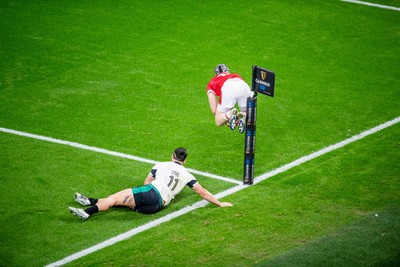 220225 - Wales v Ireland - Guinness Six Nations -  Tom Rogers of Wales beats James Lowe of Ireland to score a try 