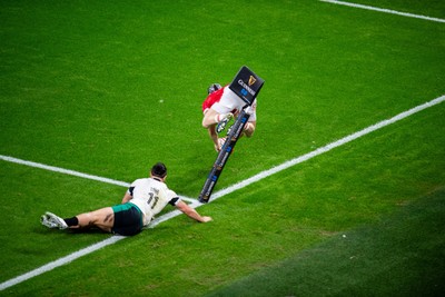 220225 - Wales v Ireland - Guinness Six Nations -  Tom Rogers of Wales beats James Lowe of Ireland to score a try 