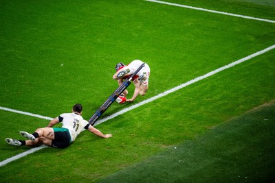 220225 - Wales v Ireland - Guinness Six Nations -  Tom Rogers of Wales beats James Lowe of Ireland to score a try 