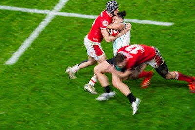 220225 - Wales v Ireland - Guinness Six Nations -  Tom Rogers of Wales and Max Llewellyn of Wales tackle James Lowe of Ireland