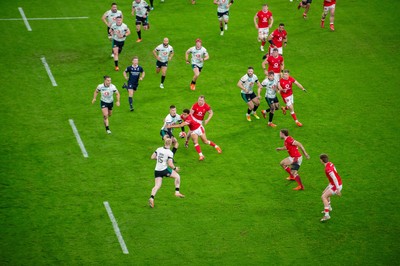 220225 - Wales v Ireland - Guinness Six Nations - Sam Prendergast of Ireland is tackled by Ben Thomas of Wales