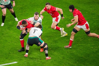 220225 - Wales v Ireland - Guinness Six Nations - Taulupe Faletau of Wales is tackled by Andrew Porter of Ireland and Peter O’Mahony of Ireland