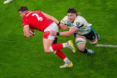 220225 - Wales v Ireland - Guinness Six Nations - Elliot Dee of Wales is tackled by Joe McCarthy of Ireland