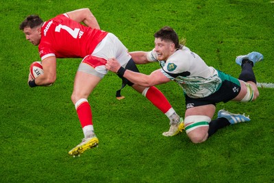 220225 - Wales v Ireland - Guinness Six Nations - Elliot Dee of Wales is tackled by Joe McCarthy of Ireland