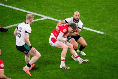 220225 - Wales v Ireland - Guinness Six Nations - Ellis Mee of Wales is tackled by Jamison Gibson-Park of Ireland