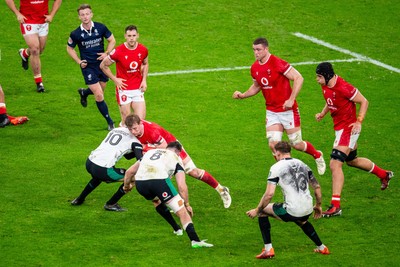 220225 - Wales v Ireland - Guinness Six Nations - Jac Morgan of Wales is tackled by Sam Prendergast of Ireland