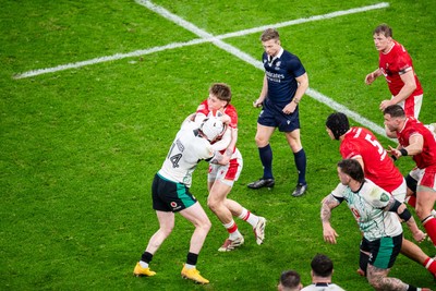 220225 - Wales v Ireland - Guinness Six Nations - Ellis Mee of Wales is tackled by Mack Hansen of Ireland