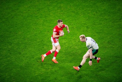 220225 - Wales v Ireland - Guinness Six Nations - Gareth Anscombe of Wales beats Jamie Osborne of Ireland