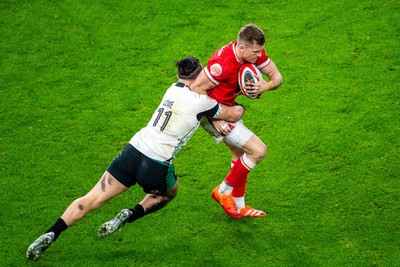 220225 - Wales v Ireland - Guinness Six Nations - Gareth Anscombe of Wales is tackled by James Lowe of Ireland