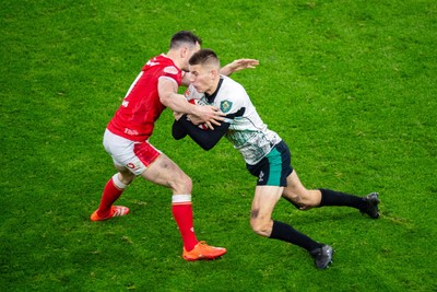 220225 - Wales v Ireland - Guinness Six Nations - Sam Prendergast of Ireland is tackled by Tomos Williams of Wales