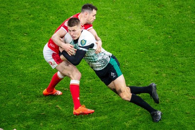 220225 - Wales v Ireland - Guinness Six Nations - Sam Prendergast of Ireland is tackled by Tomos Williams of Wales