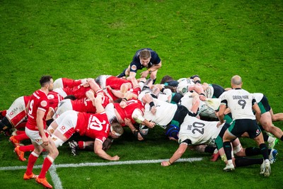 220225 - Wales v Ireland - Guinness Six Nations - Players pack down for a scrum as referee Christophe Ridley watches