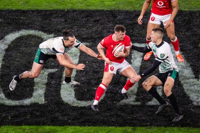 220225 - Wales v Ireland - Guinness Six Nations - Jarrod Evans of Wales is tackled by James Lowe of Ireland and Sam Prendergast of Ireland