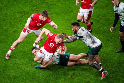 220225 - Wales v Ireland - Guinness Six Nations - Blair Murray of Wales is tackled by James Lowe of Ireland and Bundee Aki of Ireland