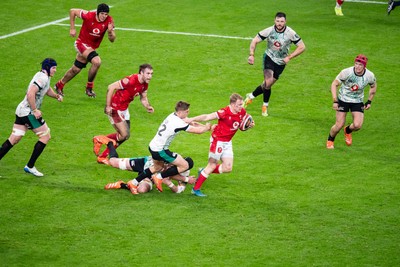 220225 - Wales v Ireland - Guinness Six Nations - Blair Murray of Wales beats the tackle of Jack Crowley of Ireland