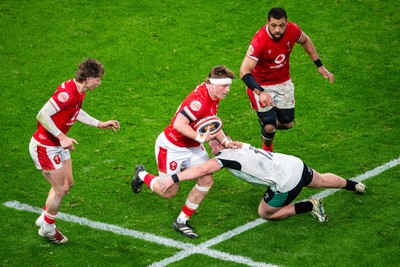 220225 - Wales v Ireland - Guinness Six Nations - Evan Lloyd of Wales is tackled by Jack Boyle of Ireland