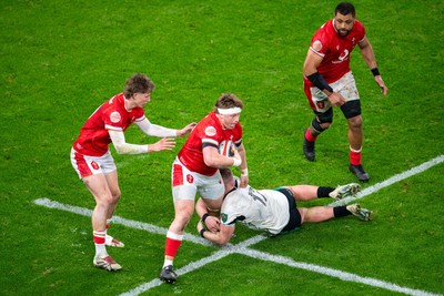 220225 - Wales v Ireland - Guinness Six Nations - Evan Lloyd of Wales is tackled by Jack Boyle of Ireland