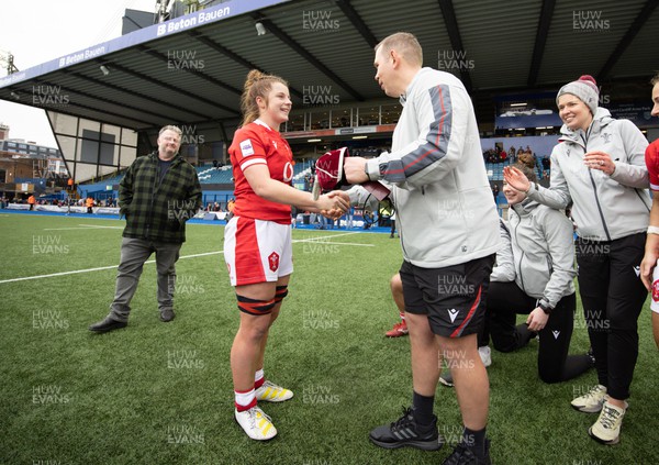 250323 - Wales v Ireland, TikToc Women’s 6 Nations - Kate Williams of Wales is presented with her Wales cap by Wales head coach Ioan Cunningham at the end of the match after making her debut