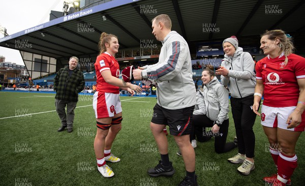 250323 - Wales v Ireland, TikToc Women’s 6 Nations - Kate Williams of Wales is presented with her Wales cap by Wales head coach Ioan Cunningham at the end of the match after making her debut