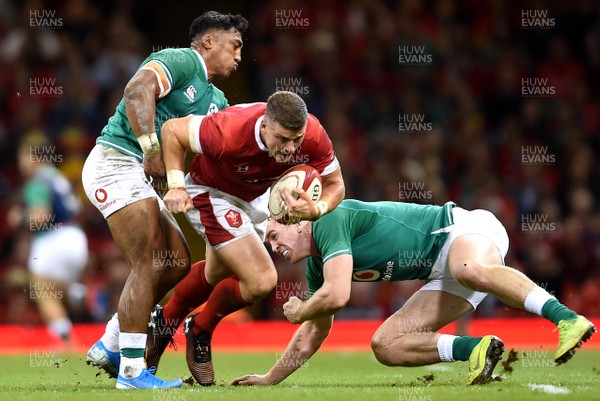 310819 - Wales v Ireland - Under Armour Series - Scott Williams of Wales is tackled by Bundee Aki and Chris Farrell of Ireland