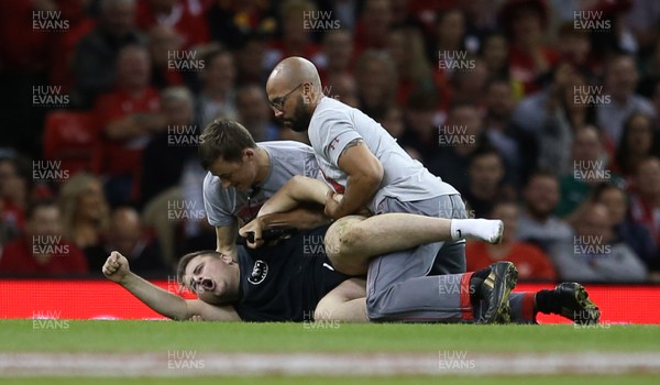 310819 - Wales v Ireland - Under Armour Summer Series - RWC Warm Up - A pitch invader is taken down by stewards