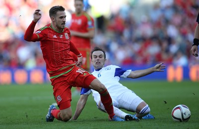 060915 - Wales v Israel, UEFA European Championship 2016 Qualifying match - Aaron Ramsey of Wales is challenged by Bibras Natcho of Israel