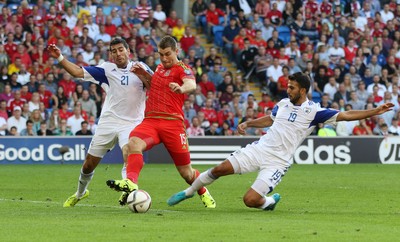 060915 - Wales v Israel, UEFA European Championship 2016 Qualifying match - Sam Vokes of Wales is tackled by Eytan Tibi of Israel and Orel Dgani of Israel