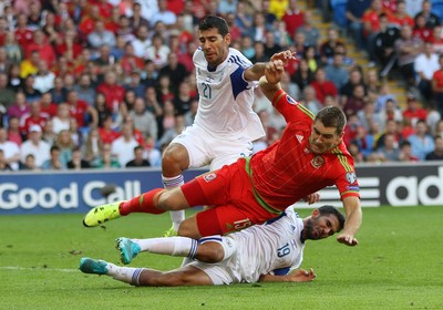 060915 - Wales v Israel, UEFA European Championship 2016 Qualifying match - Sam Vokes of Wales is tackled by Eytan Tibi of Israel and Orel Dgani of Israel