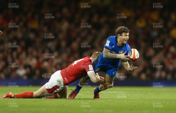 010220 - Wales v Italy, Guinness Six Nations -   Matteo Minozzi of Italy releases the ball as he is tackled by Johnny McNicholl of Wales