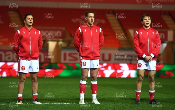 051220 - Wales v Italy - Autumn Nations Cup - Callum Sheedy, Kieran Hardy and Ioan Lloyd of Wales during the anthems 
