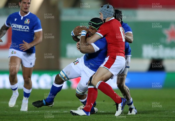 051220 - Wales v Italy - Autumn Nations Cup 2020 - Maxime Mbanda of Italy is tackled by Jonathan Davies of Wales