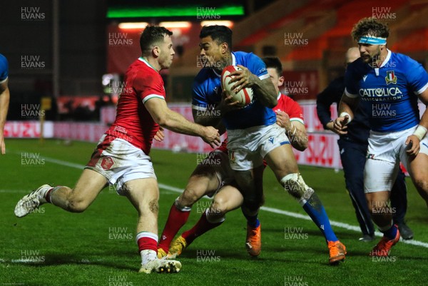051220 - Wales v Italy, Autumn Nations Cup 2020 - Montanna Ioane of Italy is stopped by Josh Adams of Wales and Gareth Davies of Wales