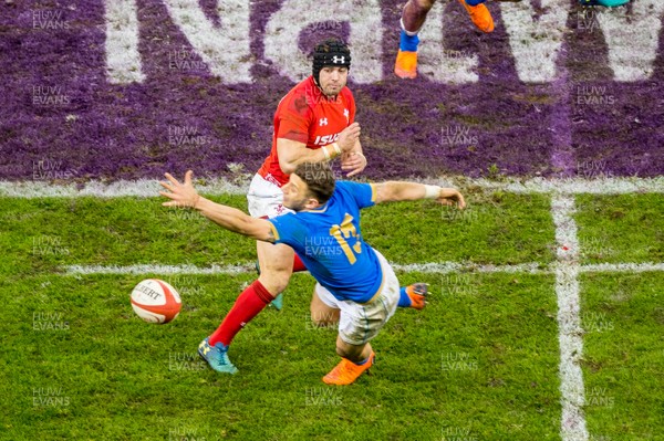 110318 - Wales v Italy, Nat West 6 Nations Championship - Leigh Halfpenny of Wales passes the ball out past Matteo Minozzi of Italy 