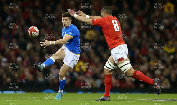 110318 - Wales v Italy - Natwest 6 Nations Championship - Tommaso Allan of Italy kicks the ball past Taulupe Faletau of Wales