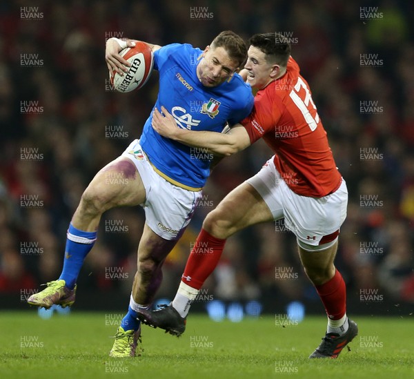 110318 - Wales v Italy - Natwest 6 Nations Championship - Tommaso Benvenuti of Italy is tackled by Owen Watkin of Wales