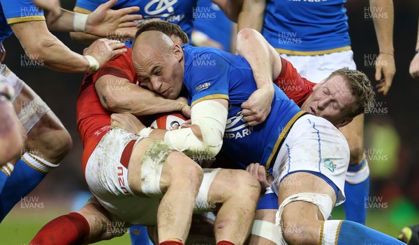 110318 - Wales v Italy - Natwest 6 Nations Championship - Sergio Parisse of Italy is taken down by James Davies and Bradley Davies of Wales