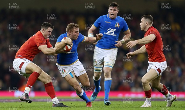 110318 - Wales v Italy - Natwest 6 Nations Championship - Giulio Bisegni of Italy is tackled by Owen Watkin and Gareth Davies of Wales