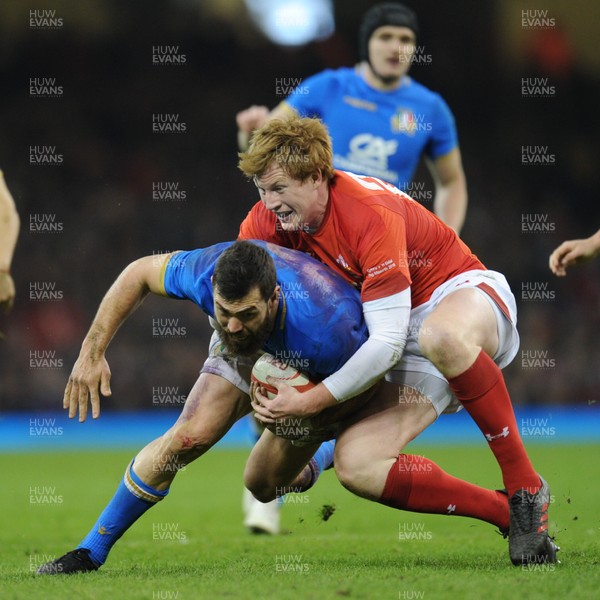 110318 - Wales v Italy - NatWest 6 Nations Championship - Jayden Hayward of Italy is tackled by Rhys Patchell of Wales 