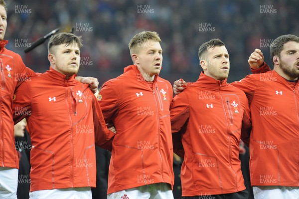 110318 - Wales v Italy - NatWest 6 Nations Championship - Steff Evans, James Davies and Gareth Davies of Wales during the anthem