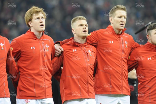 110318 - Wales v Italy - NatWest 6 Nations Championship - Rhys Patchell, Gareth Anscombe and Bradley Davies of Wales during the anthem
