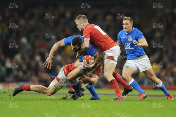 110318 - Wales v Italy - NatWest 6 Nations Championship - Jayden Hayward of Italy is tackled by James Davies of Wales  and Gareth Anscombe of Wales 