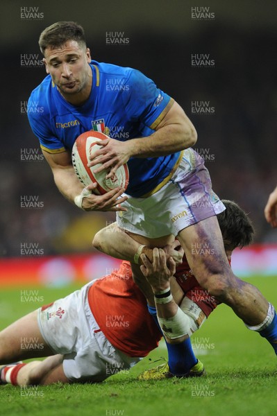 110318 - Wales v Italy - NatWest 6 Nations Championship - Tommaso Benvenuti of Italy is tackled by Steff Evans of Wales 