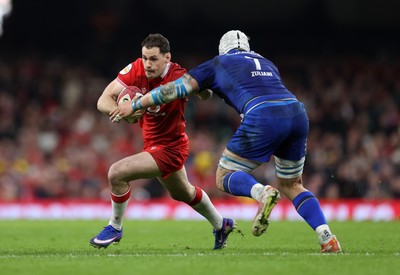 140326 - Wales v Italy - Guinness Six Nations Championship - Tomos Williams of Wales is tackled by Manuel Zuliani of Italy 