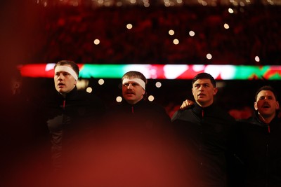 140326 - Wales v Italy - Guinness Six Nations Championship - Ben Carter, Aaron Wainwright, Louis Rees-Zammit and Tomos Williams of Wales sing the anthem