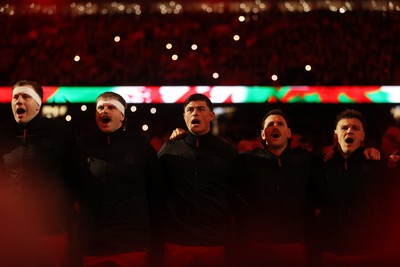 140326 - Wales v Italy - Guinness Six Nations Championship - Ben Carter, Aaron Wainwright, Louis Rees-Zammit and Tomos Williams of Wales sing the anthem
